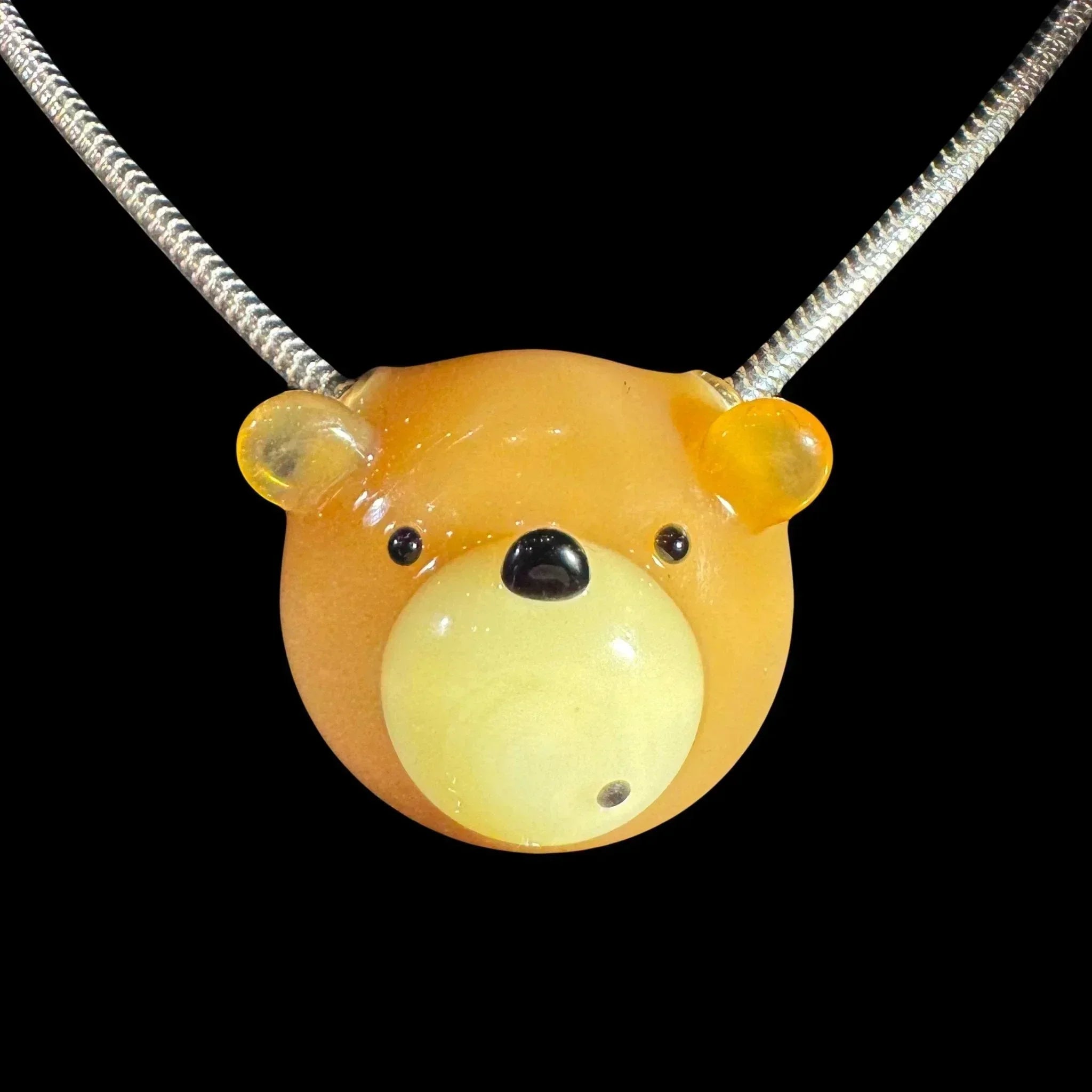 Handmade glass bear pendant necklace with orange and yellow colors on a silver chain