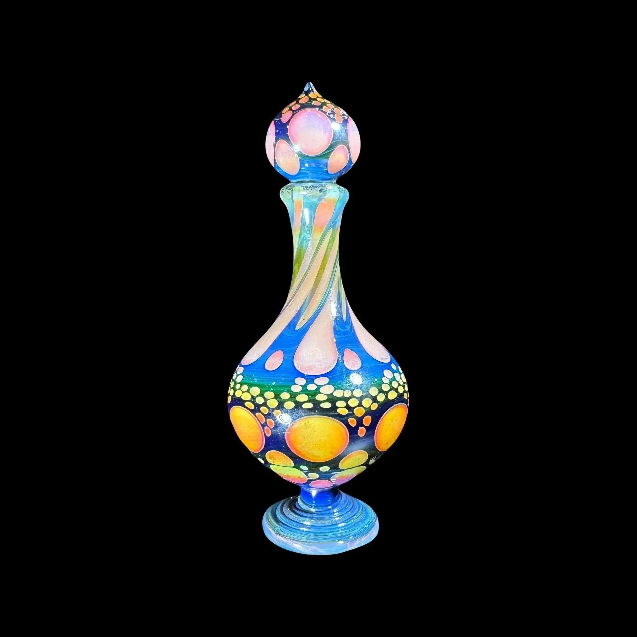 Colorful heady glass art vase with vibrant hand-blown patterns on black background