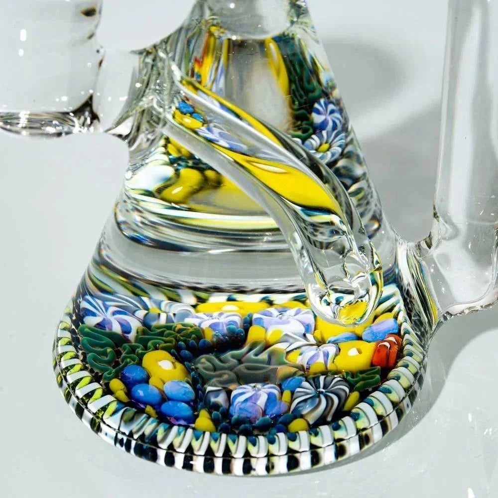 Close-up of a colorful heady glass water pipe base with intricate millefiori designs
