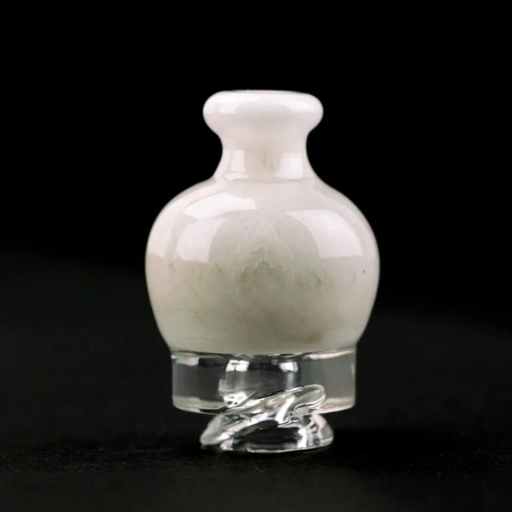 White glass carb cap with clear spiral base on black background