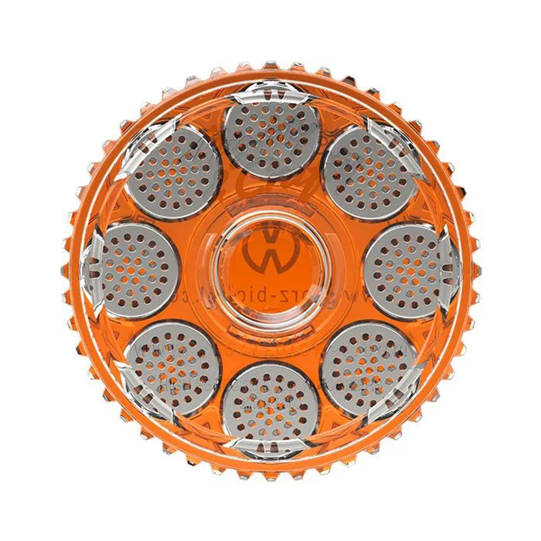Top view of an orange herb grinder with multiple metal holes and textured edge