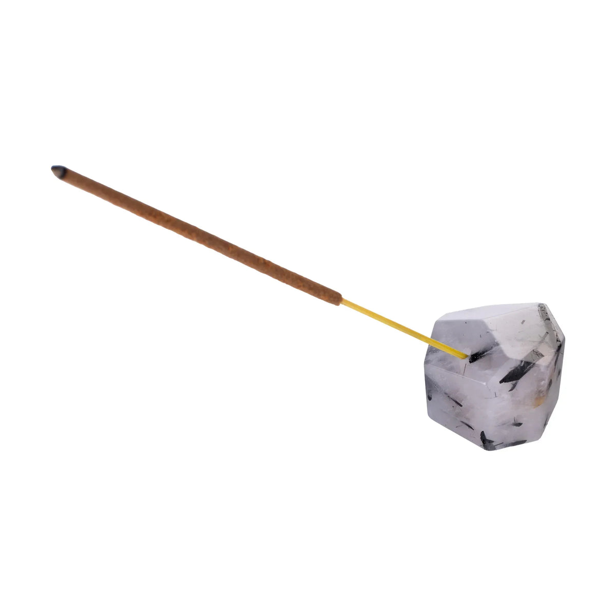 Crystal gemstone incense holder with a brown incense stick on white background