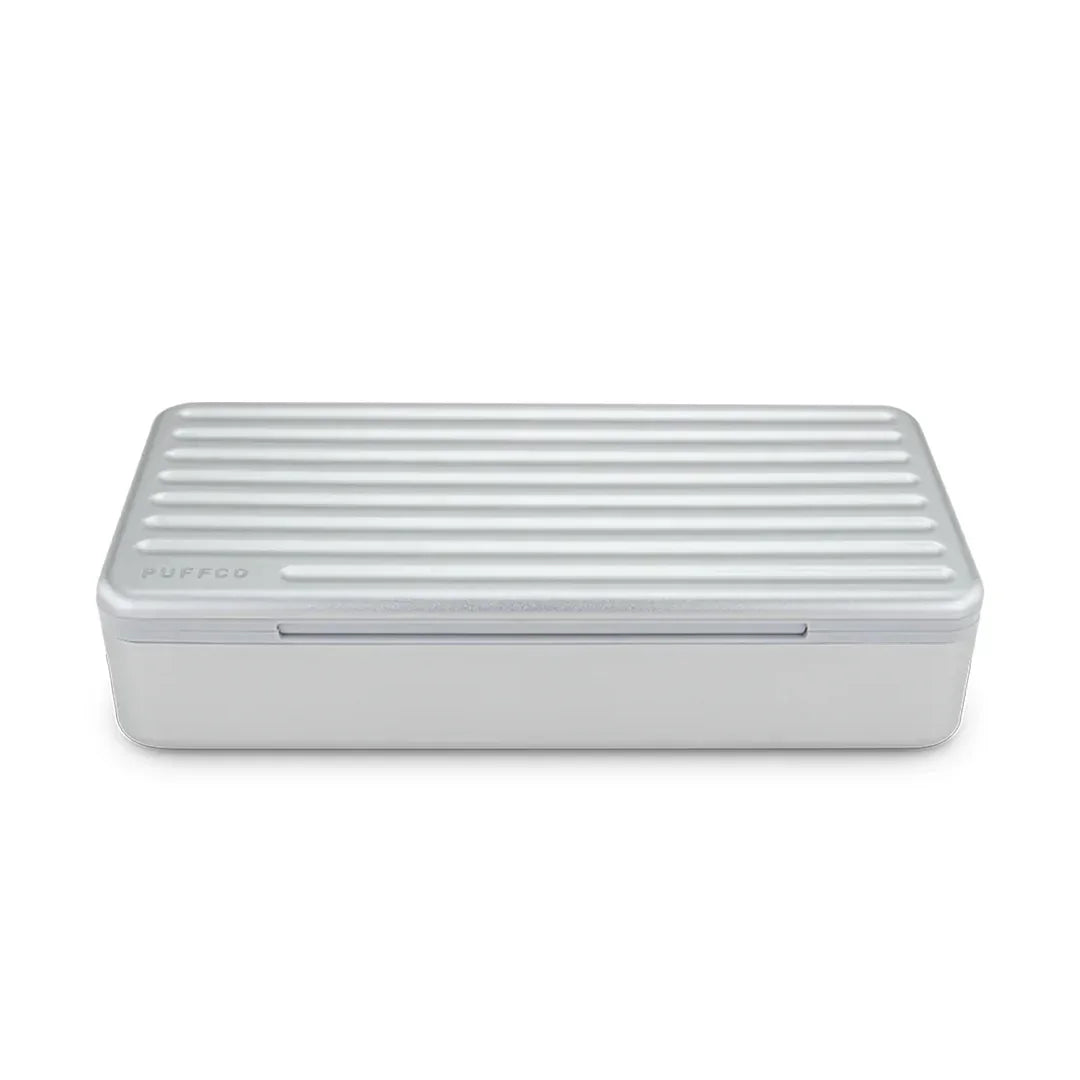 Silver Puffco storage case with a ridged lid, minimalist design, product for glass accessories