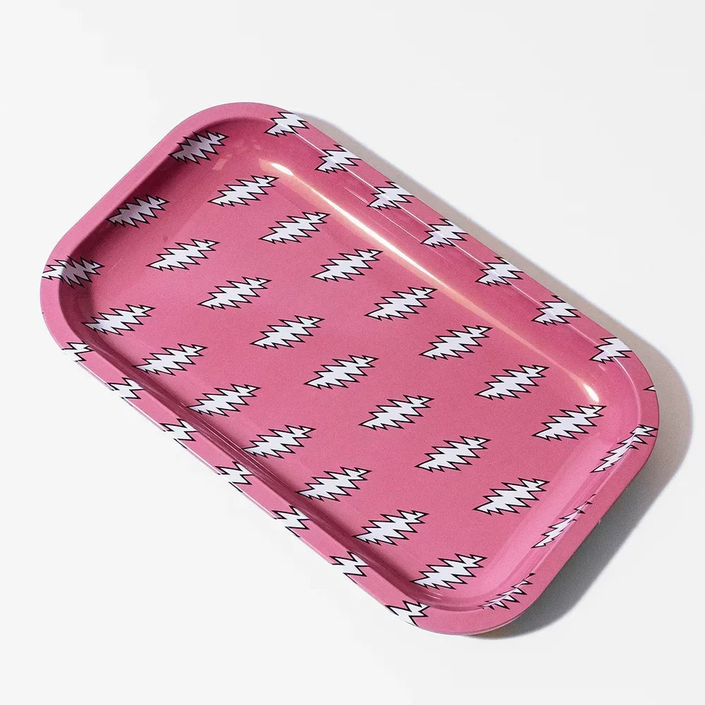 Pink metal rolling tray with white lightning bolt pattern on a white background