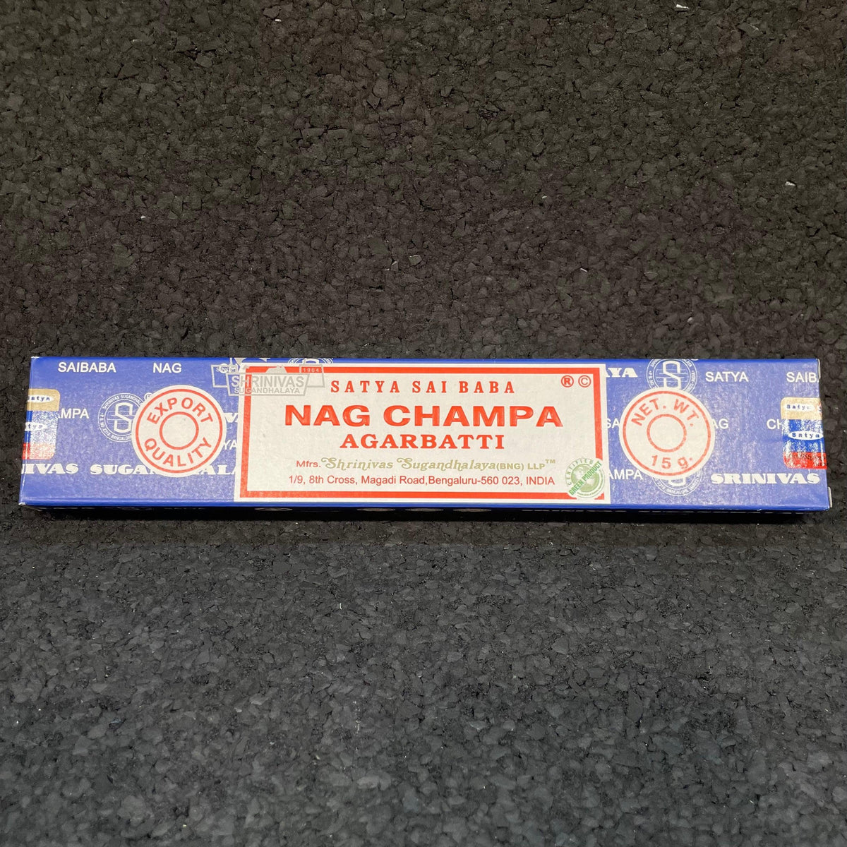 Satya Sai Baba Nag Champa incense sticks blue box on a black textured surface