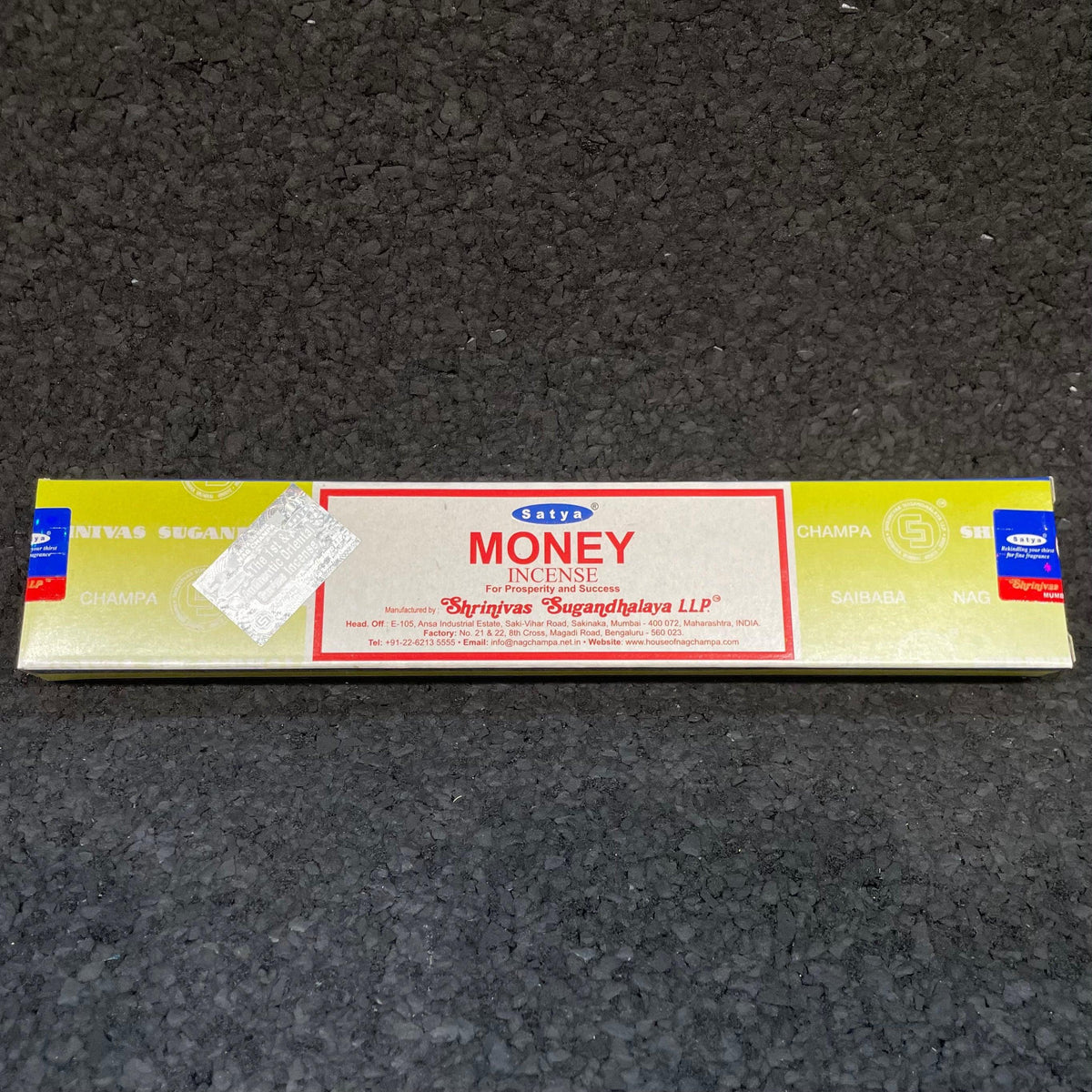 Satya Money incense sticks box on black textured surface, aromatherapy product packaging