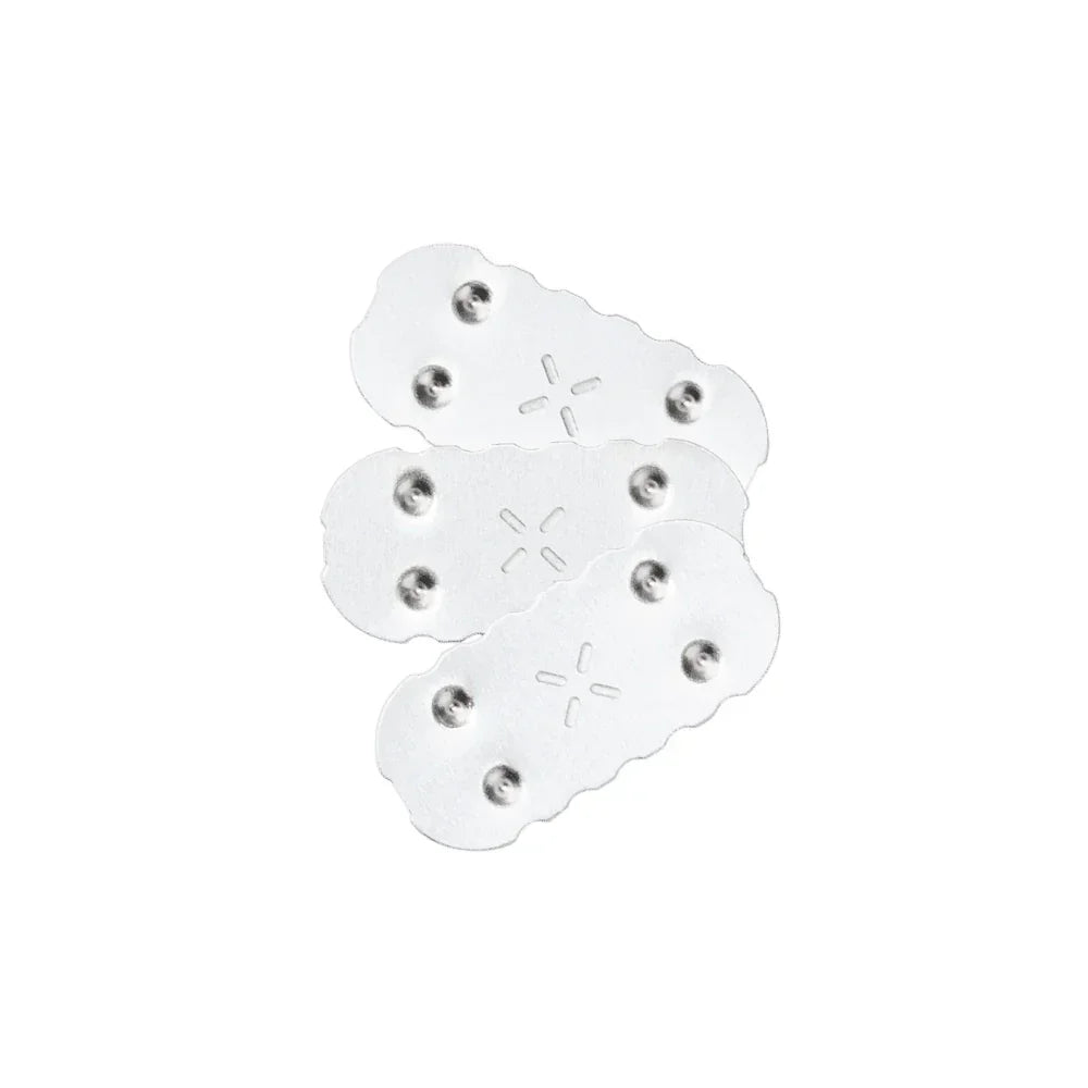 Three stainless steel vaporizer concentrate pads with airflow holes on white background