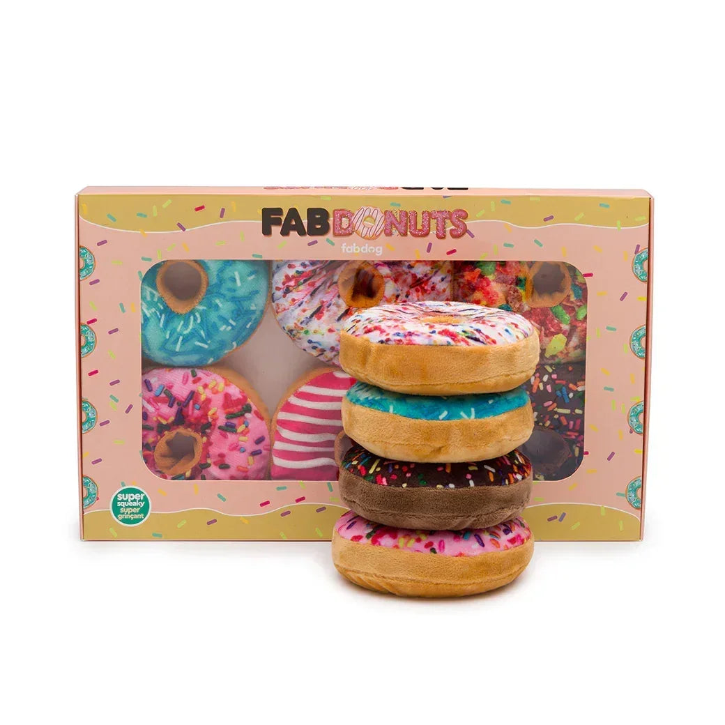Assorted plush donut dog toys in colorful sprinkle designs, displayed with packaging box