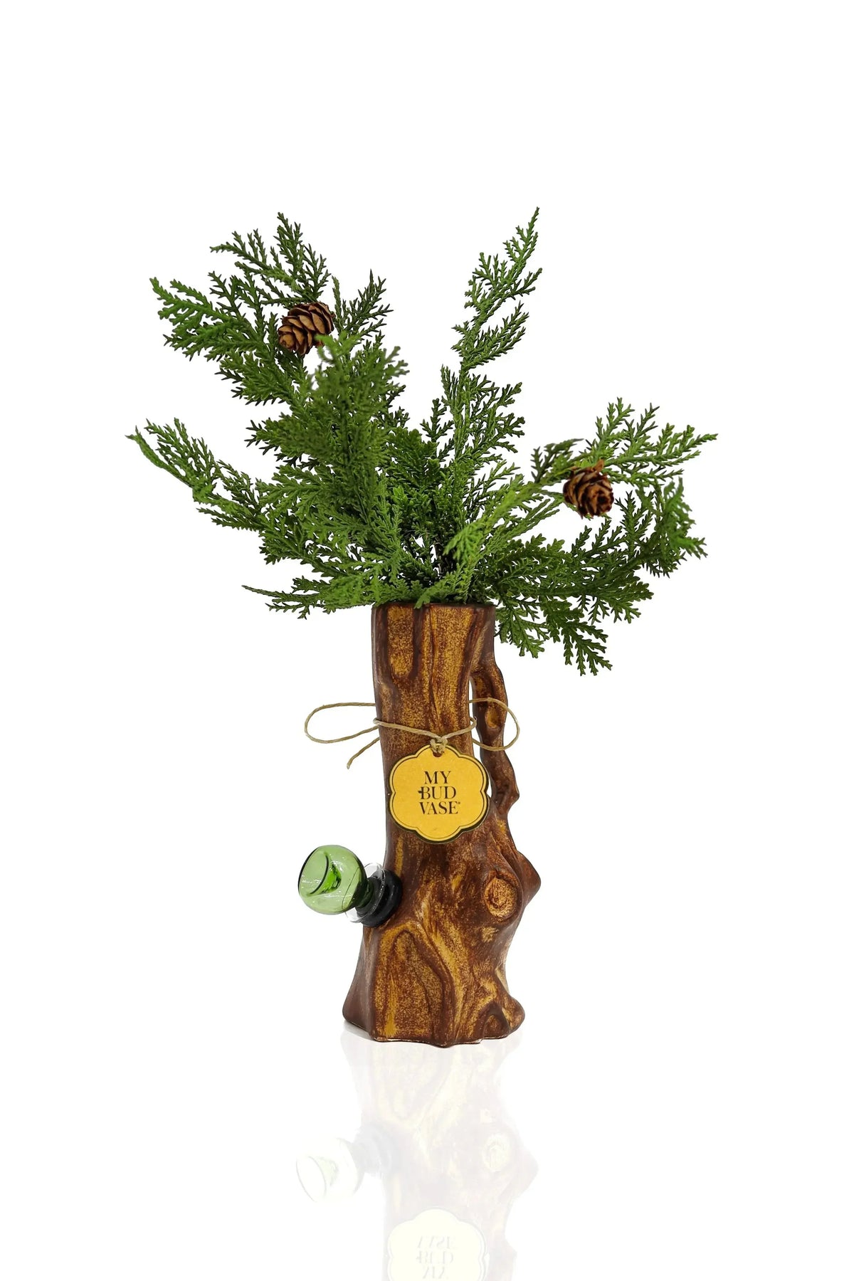 Tree trunk-shaped glass vase with pine branches, pinecones, and label reading 'My Bud Vase'