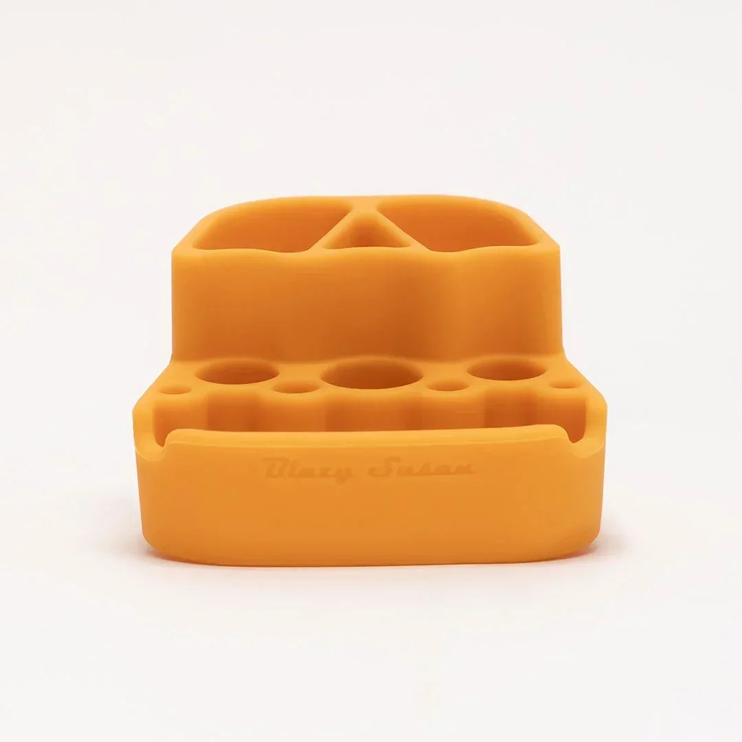 Yellow silicone smoking accessory organizer with multiple slots on a white background