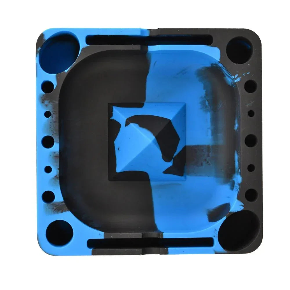 Square silicone ashtray in black and blue with built-in holder slots and grooves.