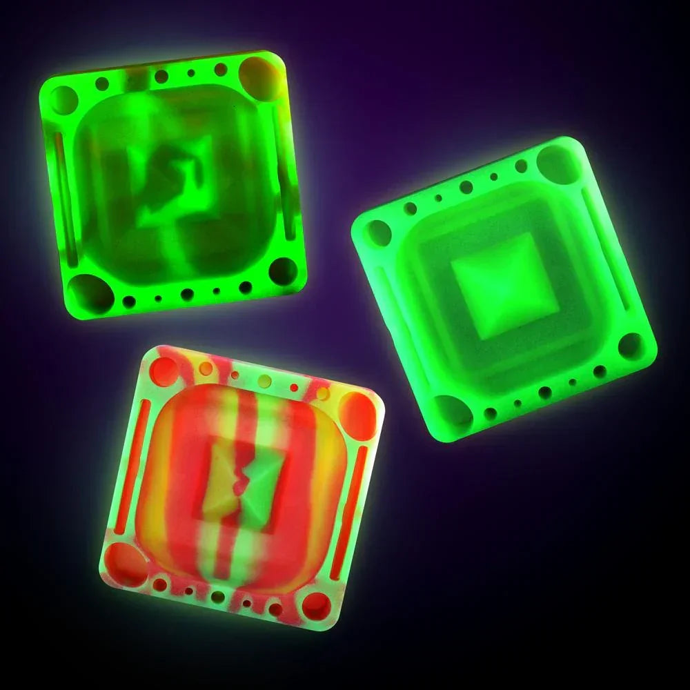 Three glowing square glass carb caps in neon green and red hues on a dark background.