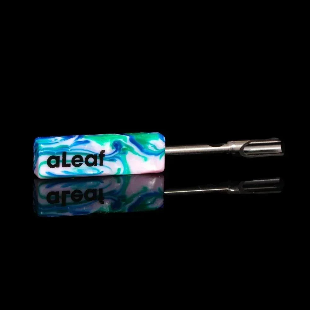 Marbled resin and metal dab tool with aLeaf logo, shown on black reflective background.