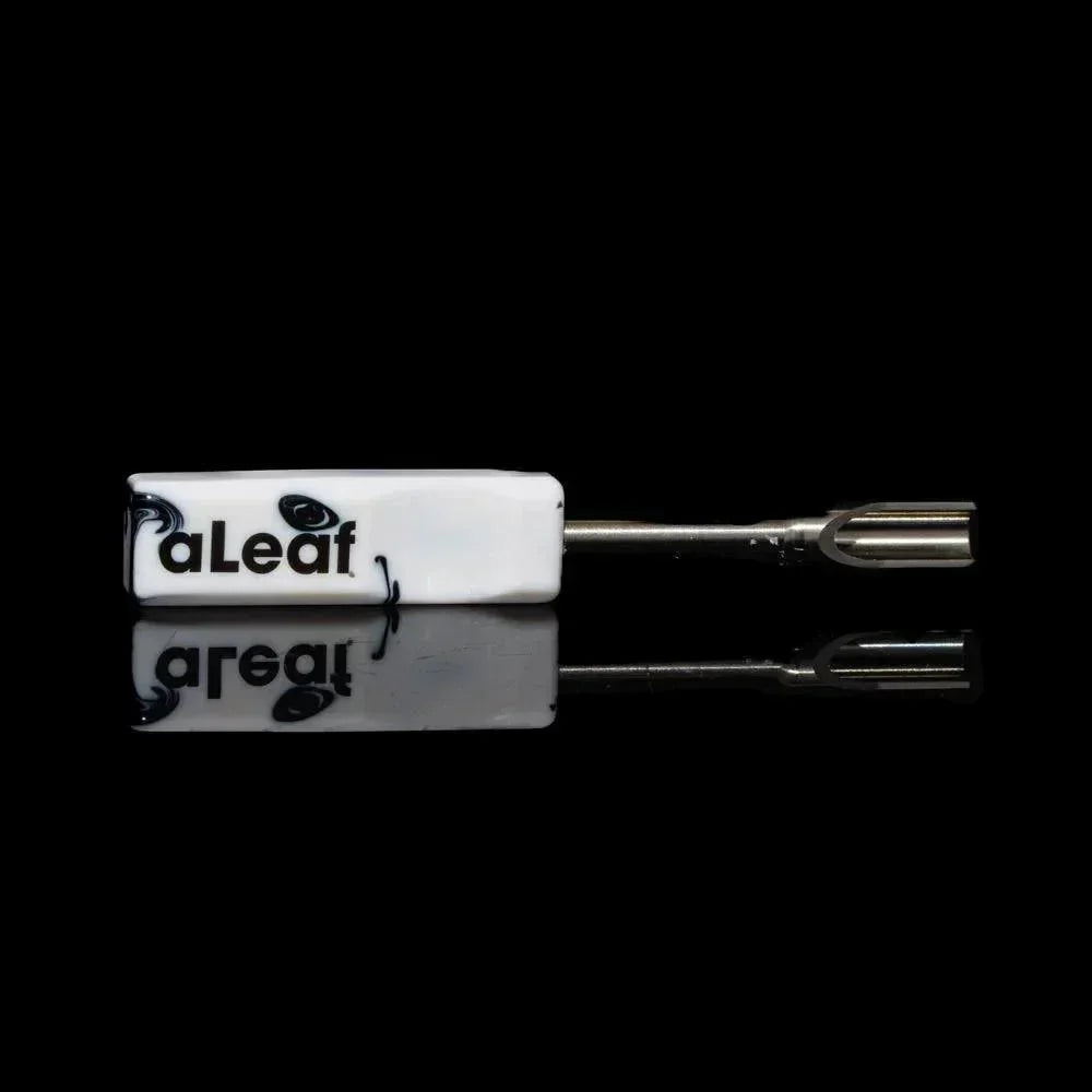 White resin dab tool with metal scoop tip, black aLeaf logo, on a reflective black surface