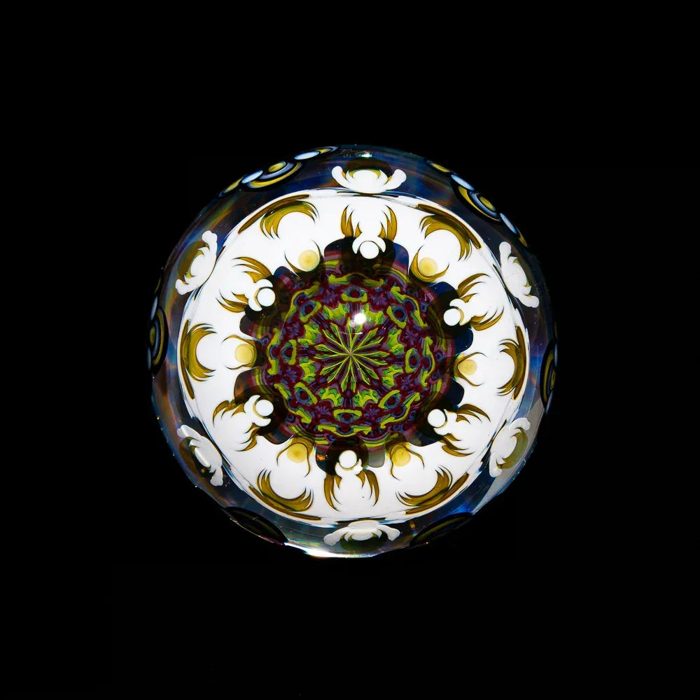 Heady glass marble with intricate, colorful mandala pattern and gold accents on black background