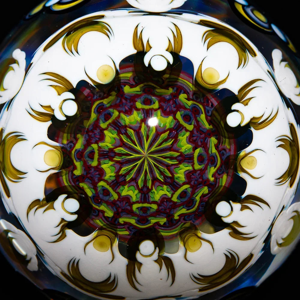 Close-up of intricate mandala glass art with vibrant colors and kaleidoscopic patterns.