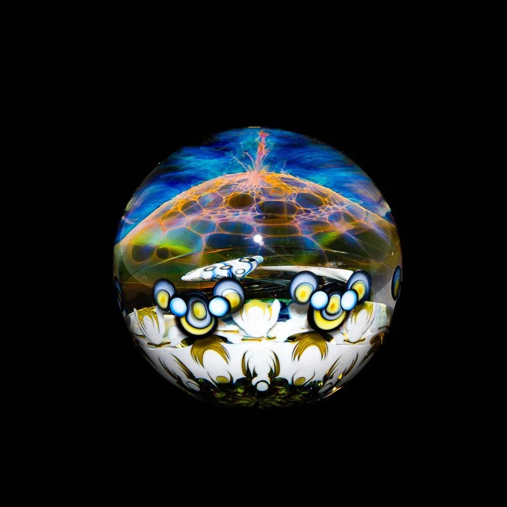 Handcrafted glass marble with vibrant psychedelic patterns and detailed millefiori designs