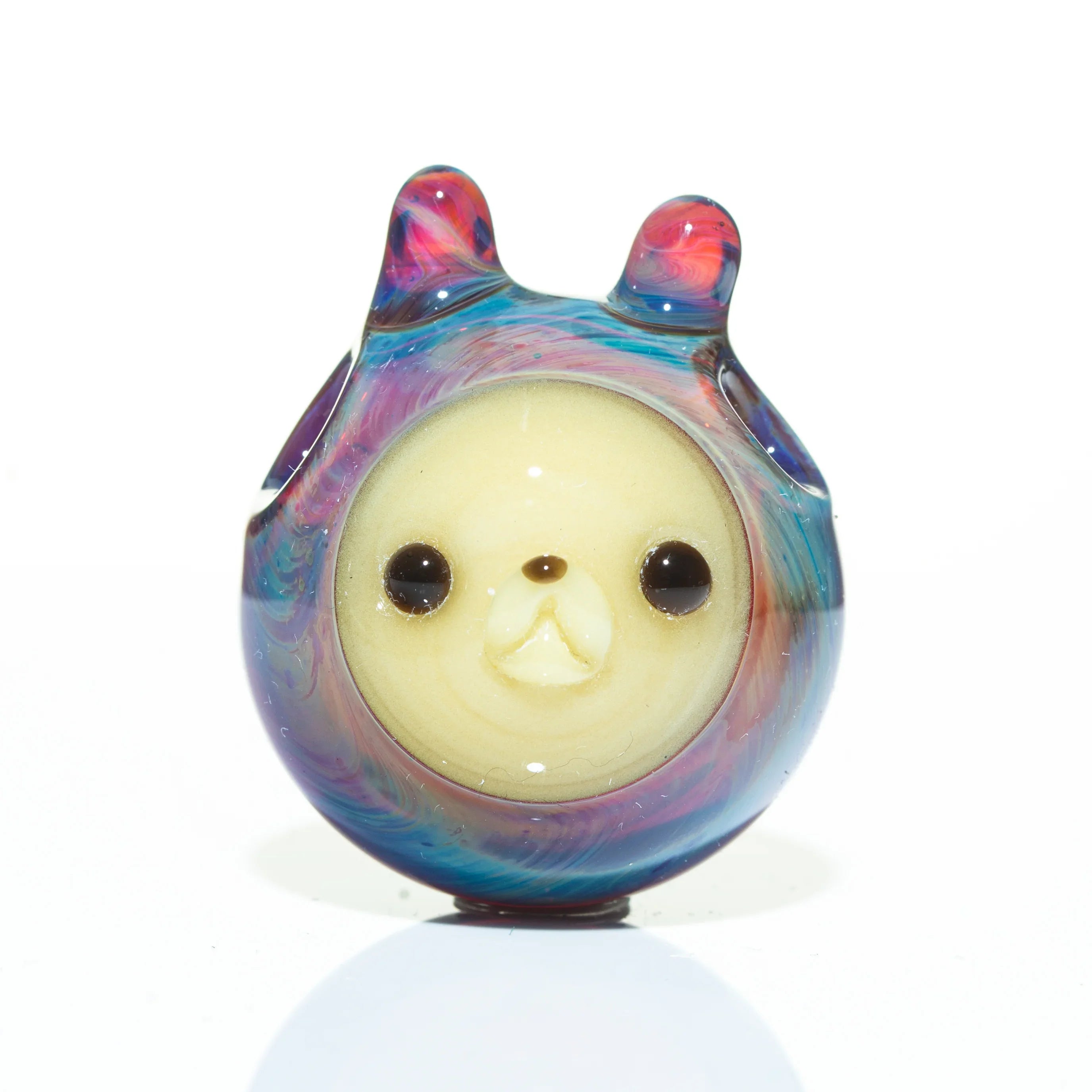 Hand-blown glass pendant with animal face and amber blue swirled accents