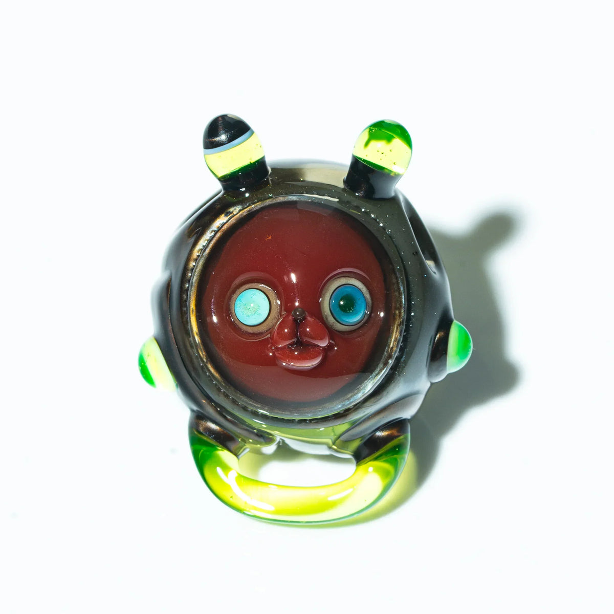 Aquarius glass pendant with cartoon animal face, colorful eyes, and green accents