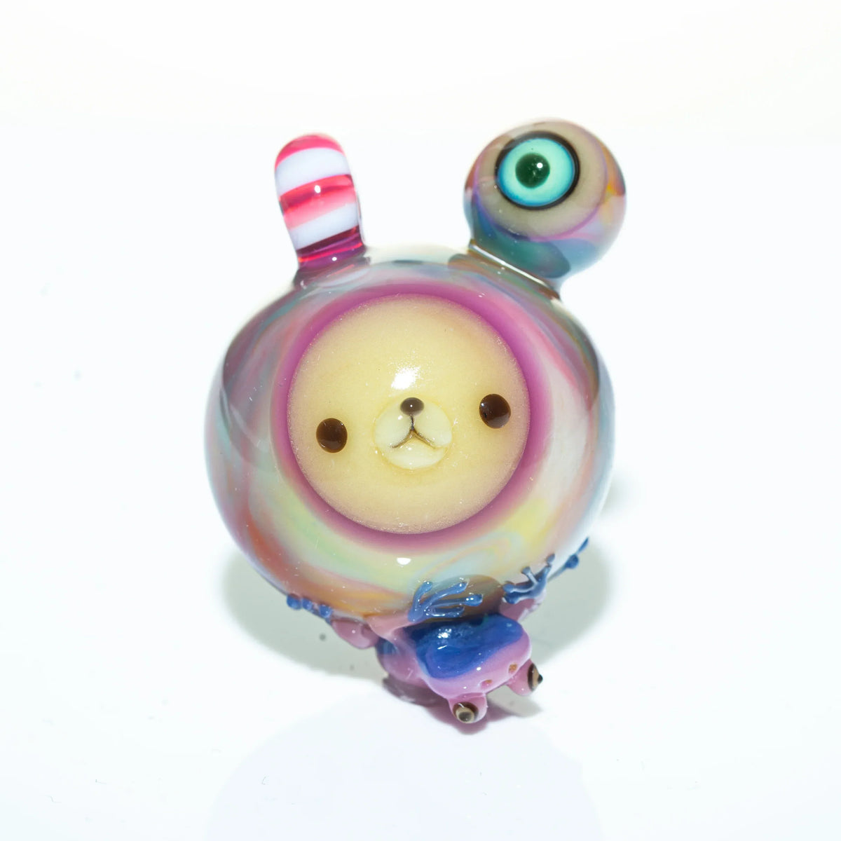 Colorful glass pendant with bear face, striped ear, and large eye, on white background