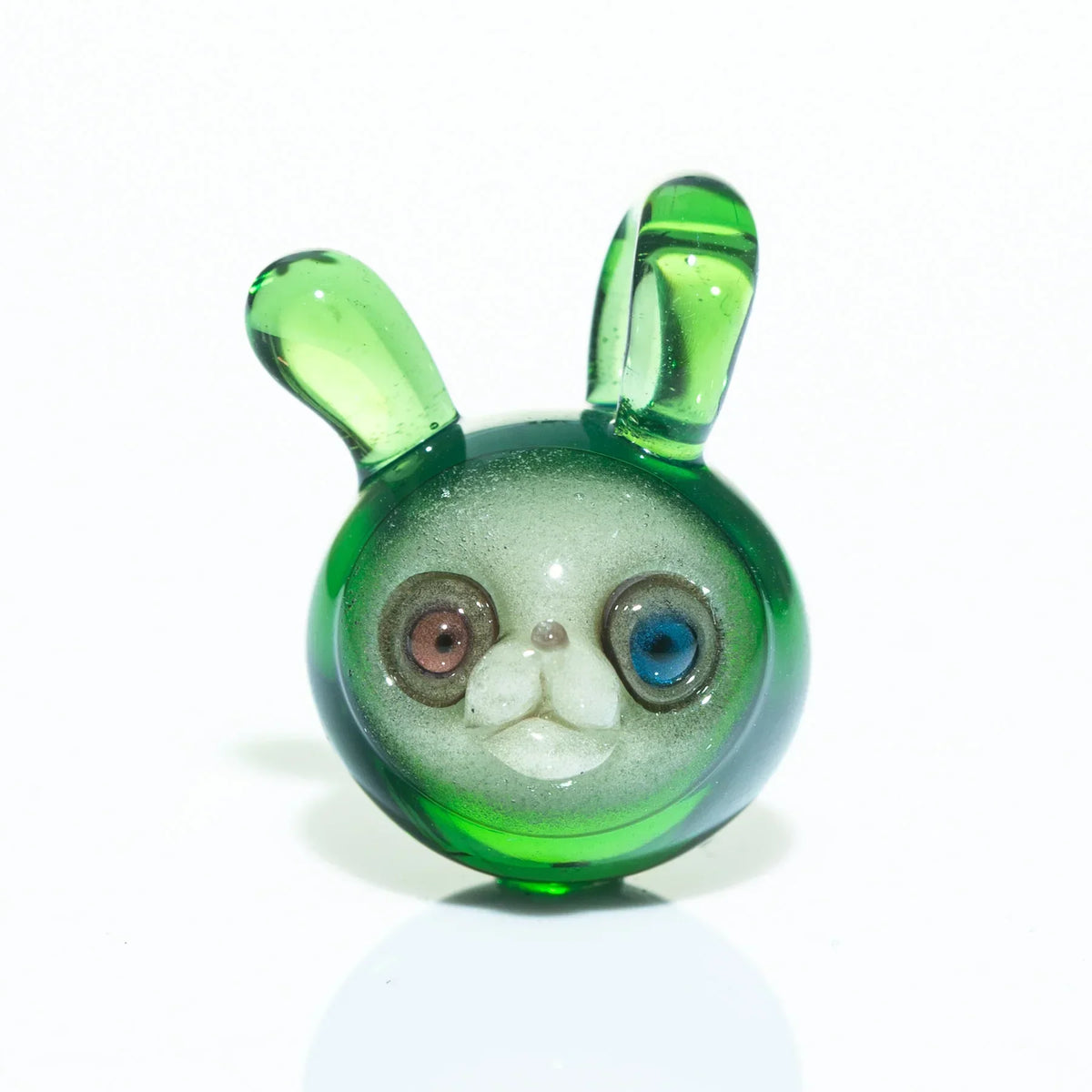 Green glass pendant shaped like an animal head with colorful eyes and upright ears
