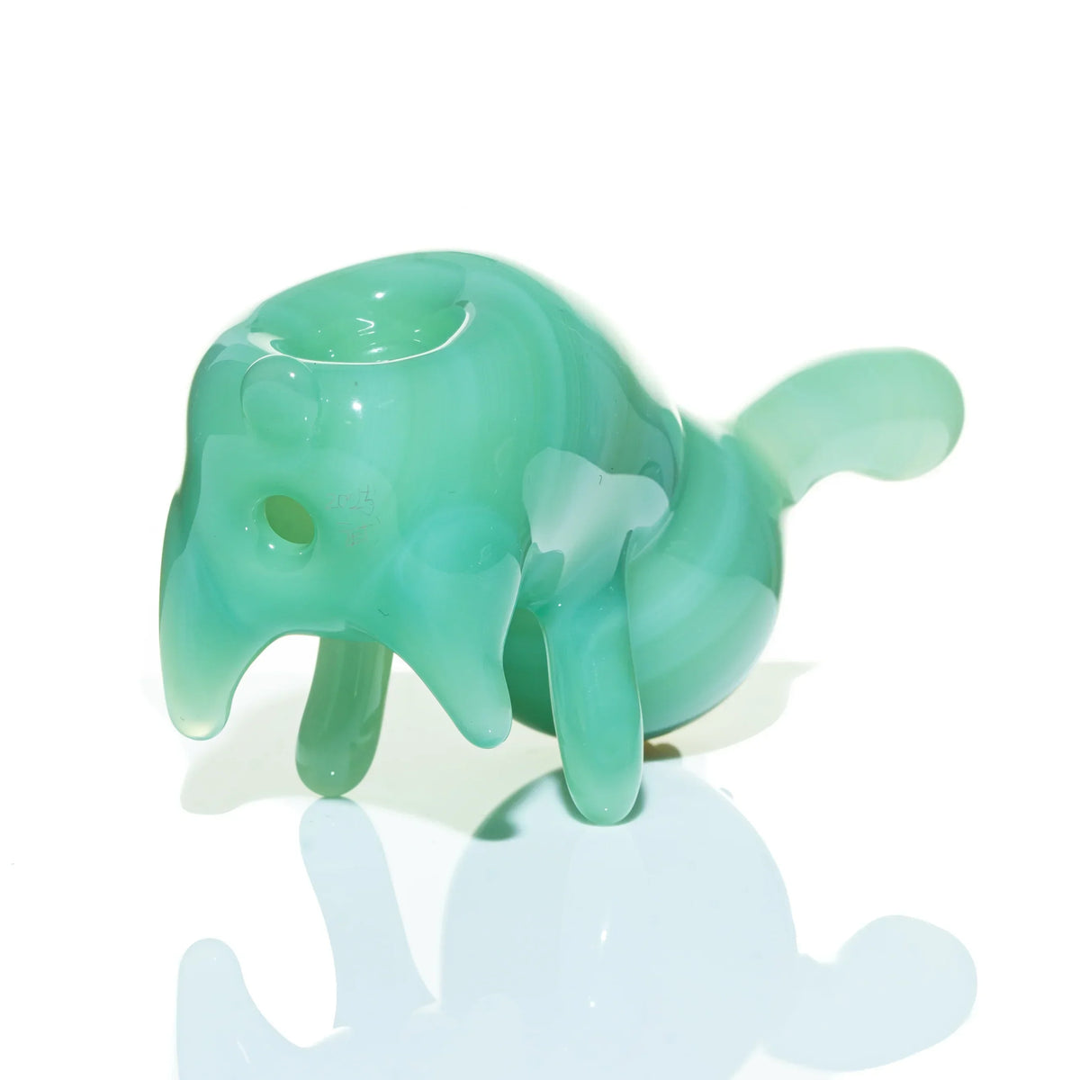 Mint green glass elephant pipe with smooth finish and four legs on a white background