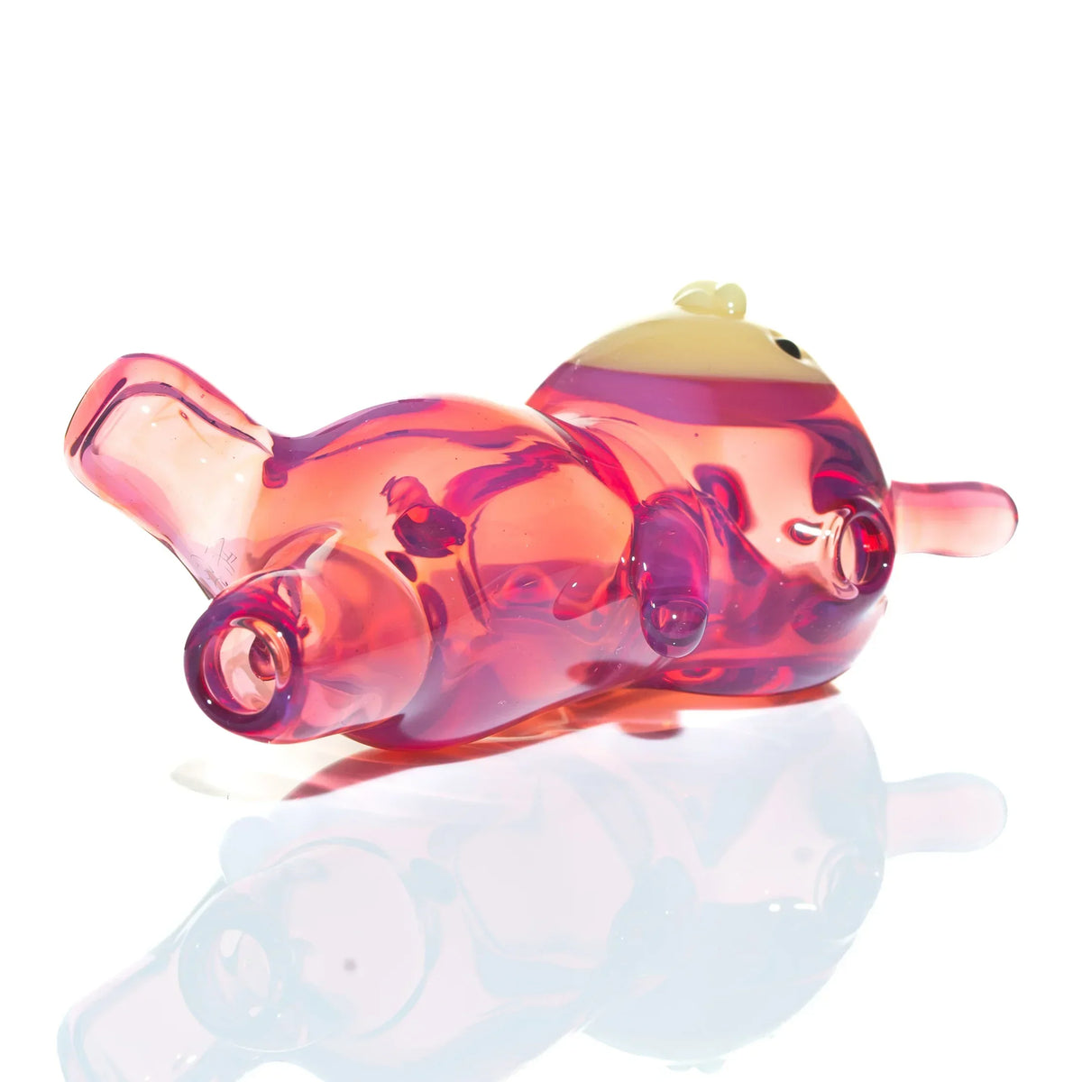 Telemagenta glass smoking pipe shaped like a reclining character with clear pink body
