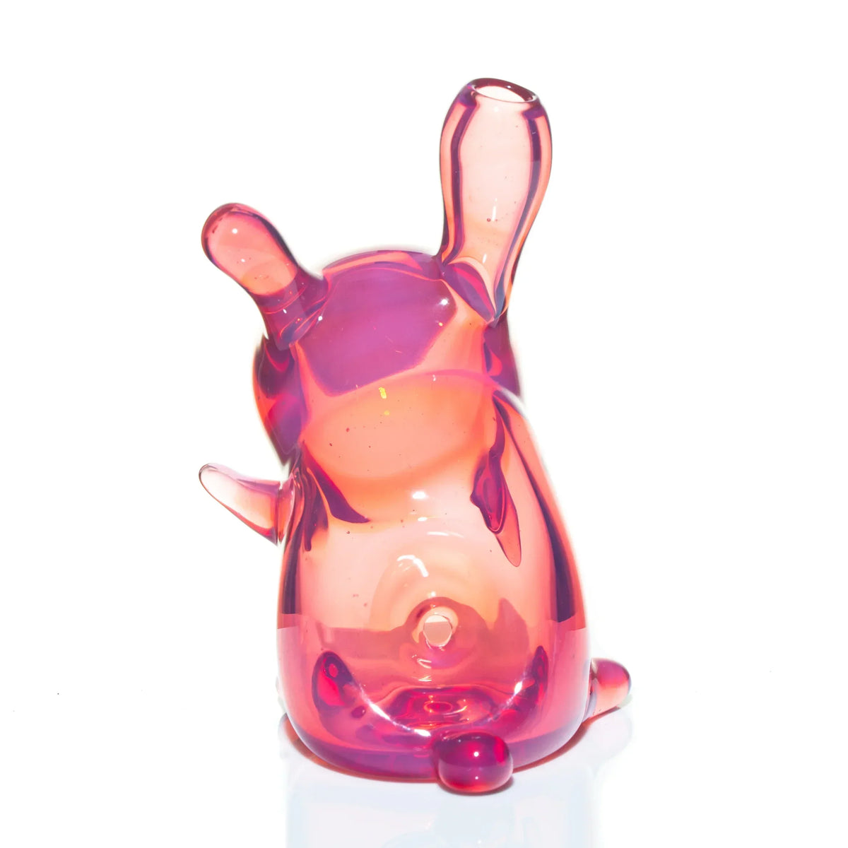 Telemagenta glass art pipe shaped like a sitting character with raised ears on white background