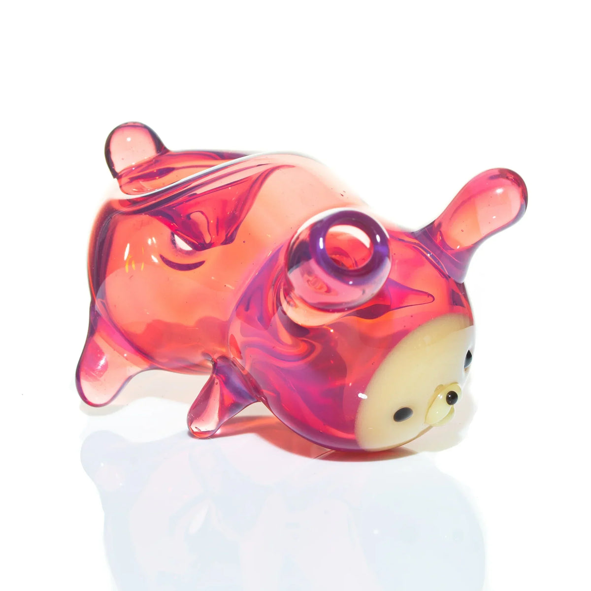 Handcrafted pink glass animal-shaped pipe with whimsical face on white background