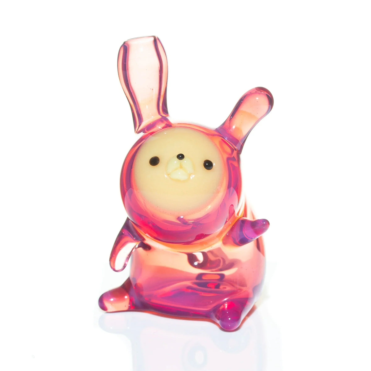 Pink and yellow glass animal carb cap with upright ears and cute face, on white background