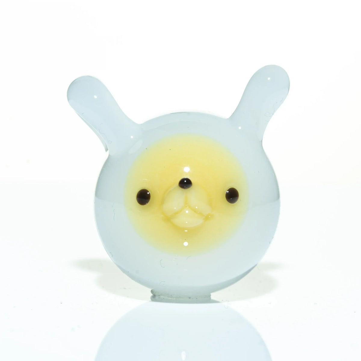 White and yellow glass pendant shaped like a bear face with round ears and black eyes