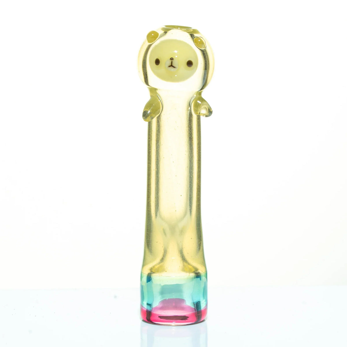 Yellow glass chillum pipe with bear face and pastel rainbow base on white background