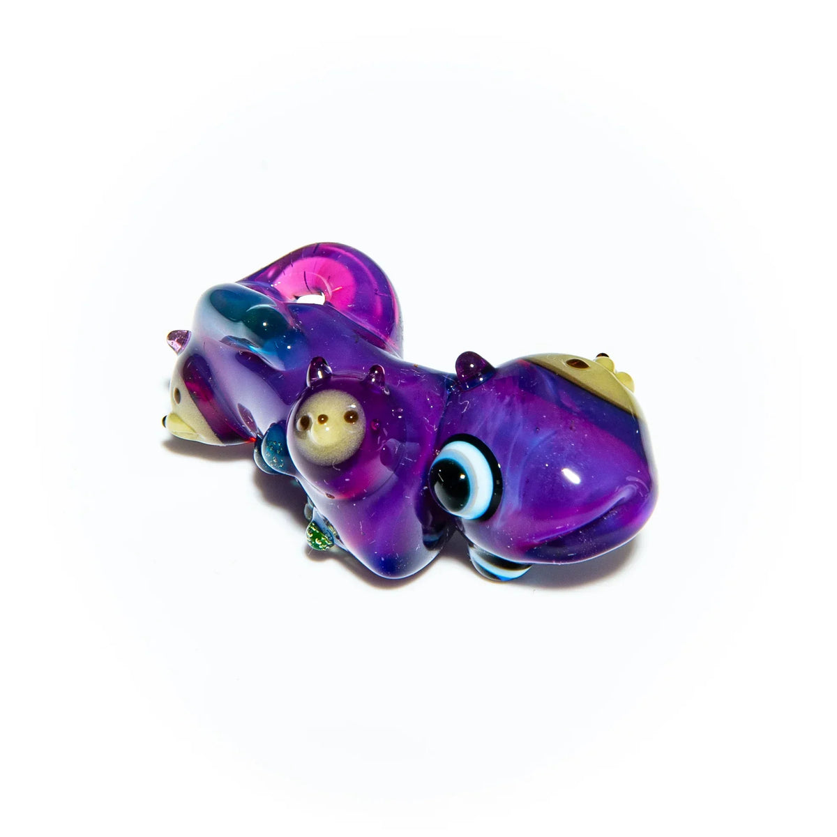 Colorful purple glass squid pipe with detailed eyes and whimsical accents, isolated on white