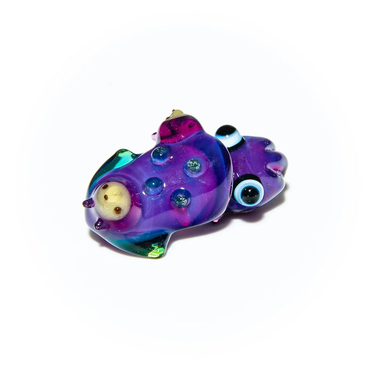Colorful purple glass squid sculpture with blue eyes and textured details on white background.