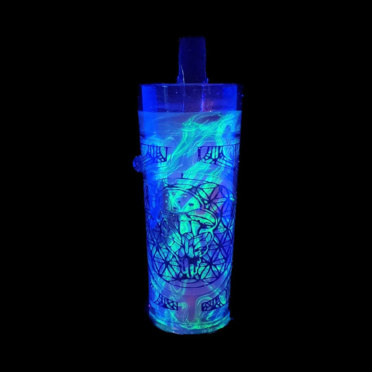 UV-reactive glass sippy cup with psychedelic patterns and glowing blue-green designs
