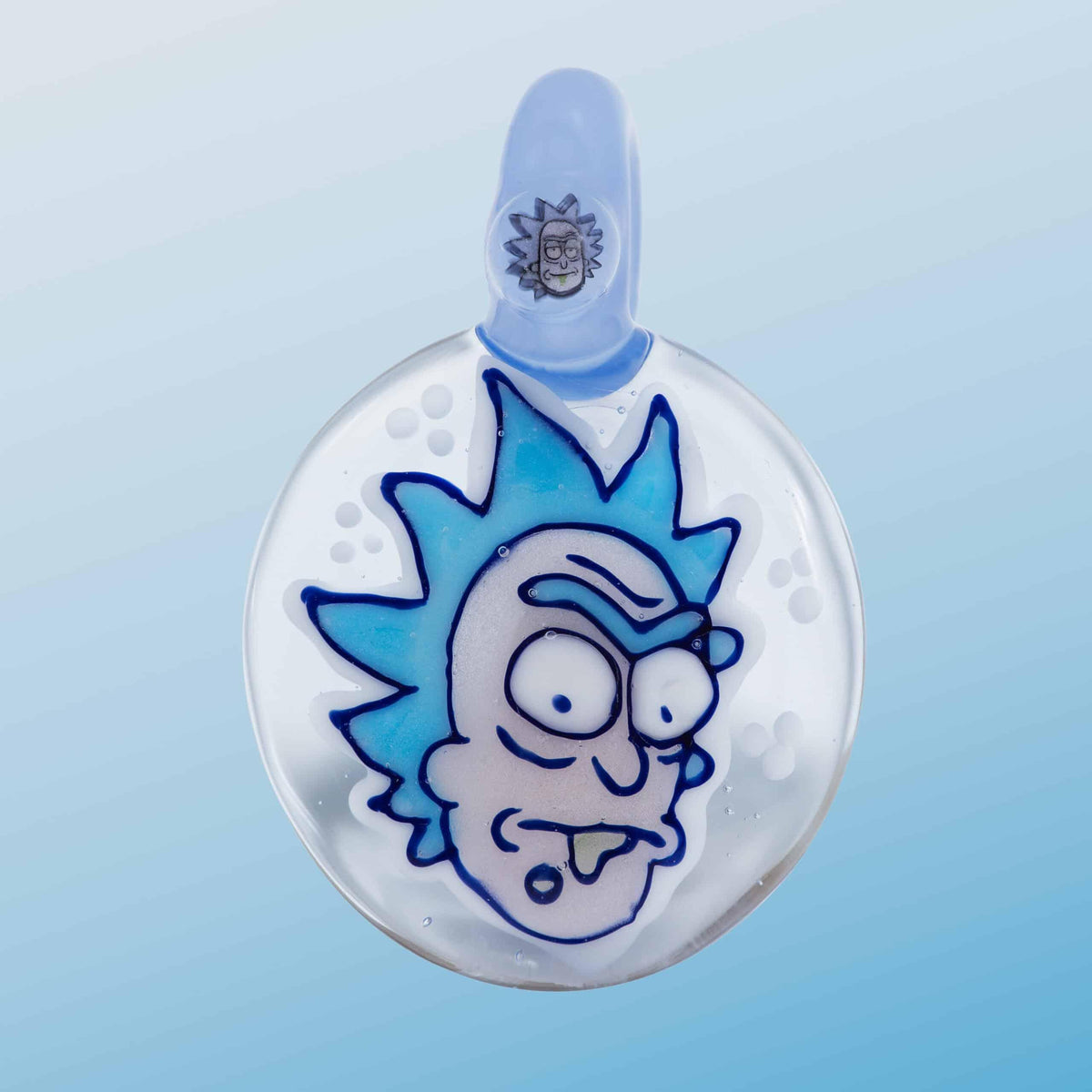 Handmade glass pendant featuring a cartoon blue-haired face on a clear background