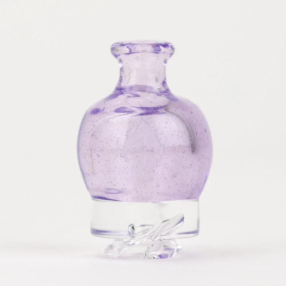 Purple glass carb cap with clear base for concentrates, displayed on white background