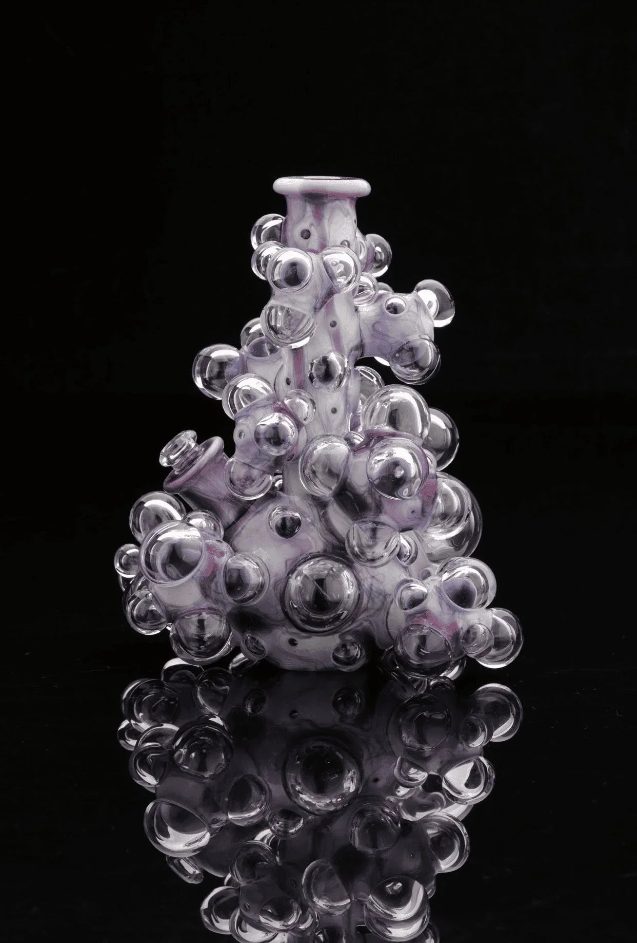 Heady glass water pipe with bubble accents, artistic purple and clear design on black background