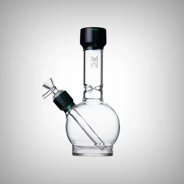 Clear glass water pipe with round base and dark green accents on a white background