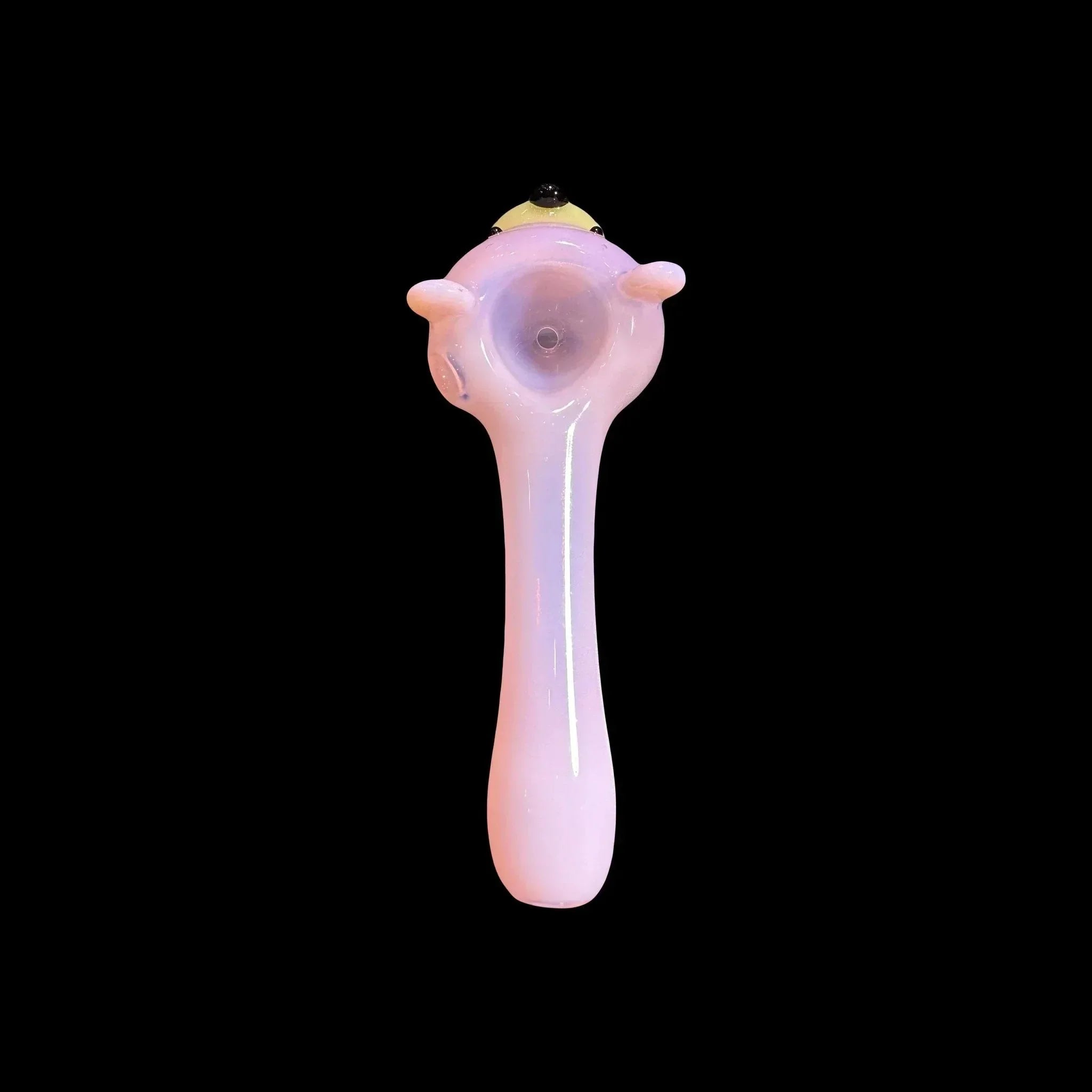 Pink glass hand pipe with cartoon-style face design on a black background