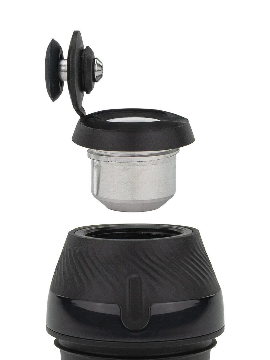 Vaporizer chamber and black lid with attached dab tool, close-up on white background