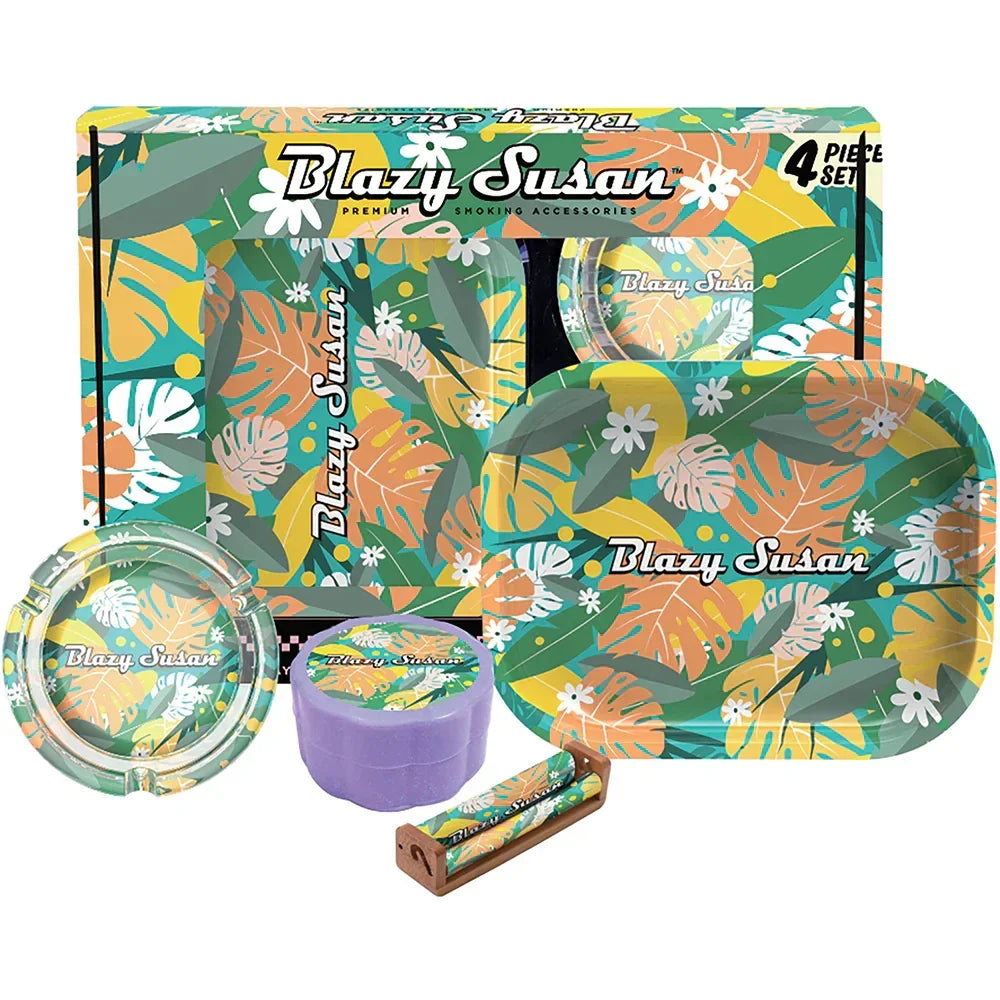 Blazy Susan 4-piece smoking accessory set with tropical leaf design, rolling tray, ashtray, and grinder.