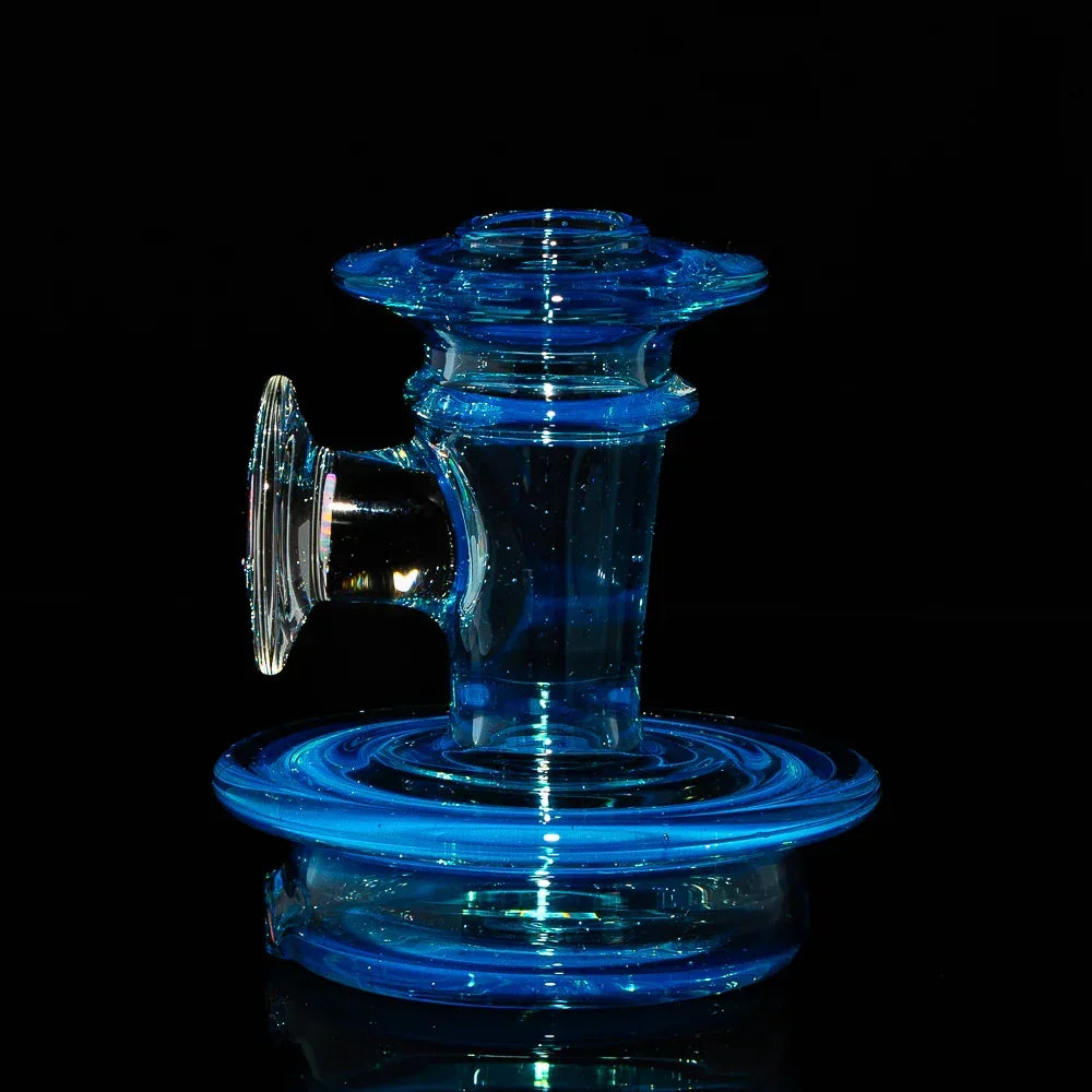 Blue glass attachment for water pipe with wide base and flared mouthpiece on black background.