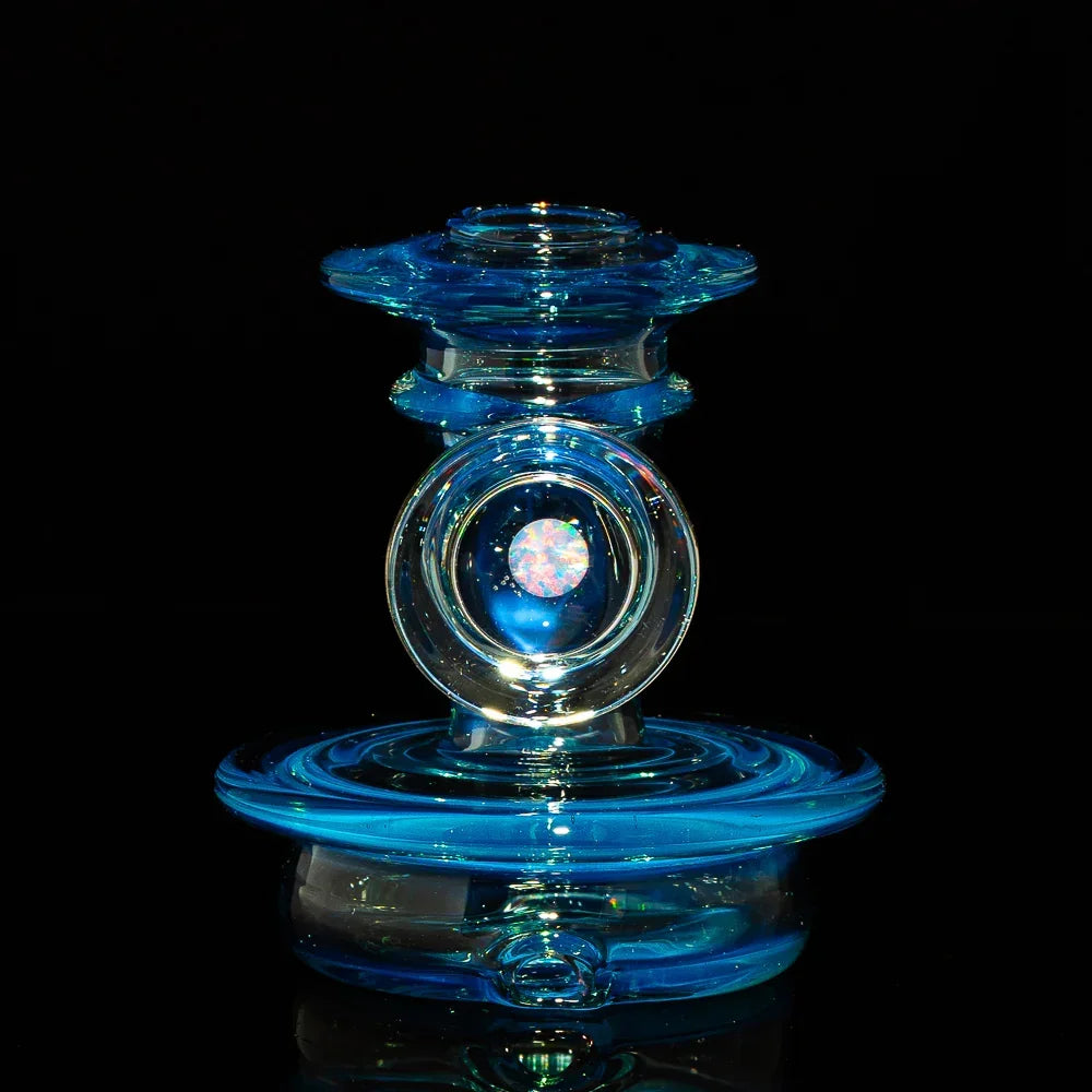 Blue glass carb cap with opal marble centerpiece on black background