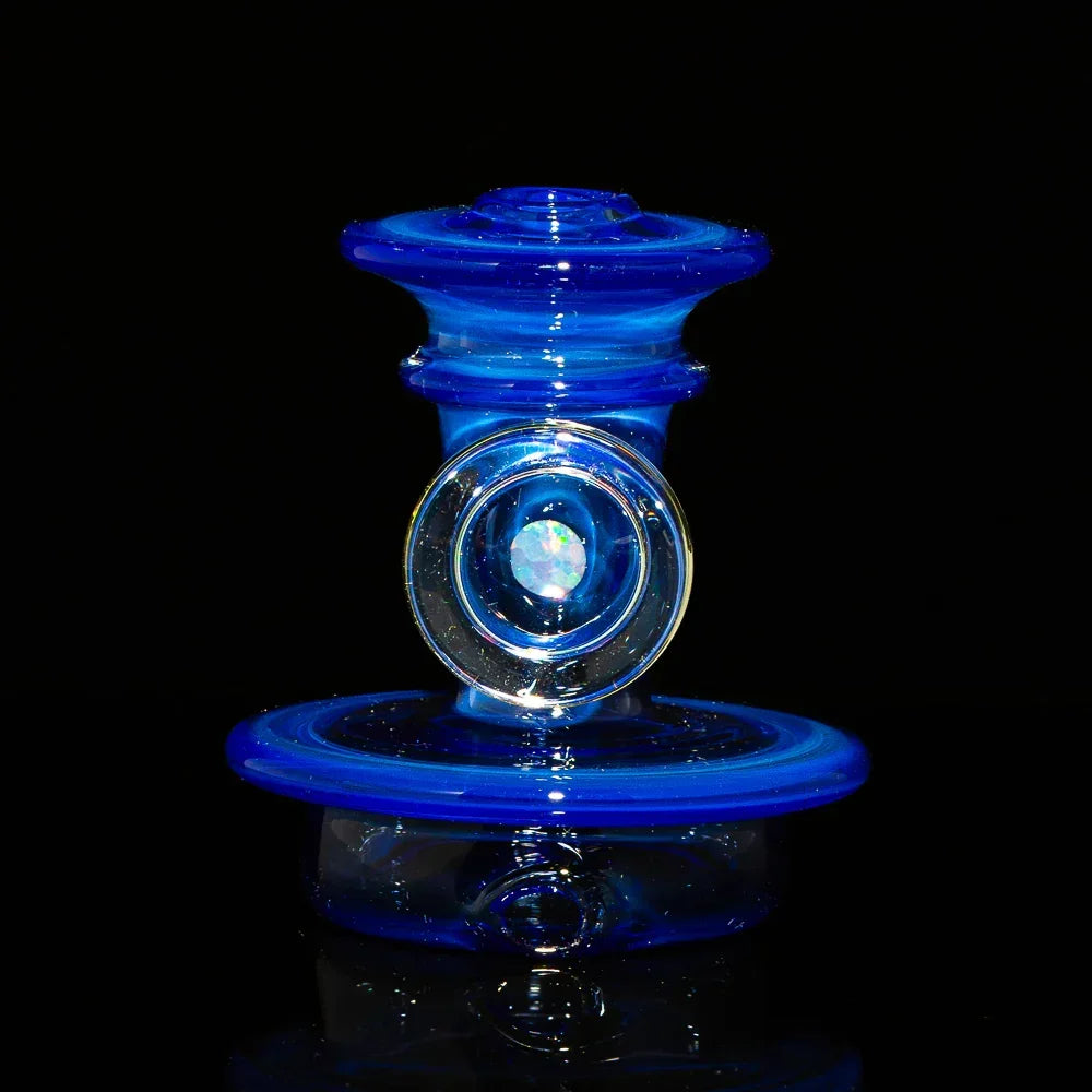 Blue glass carb cap with opal accent for dab rig on black background