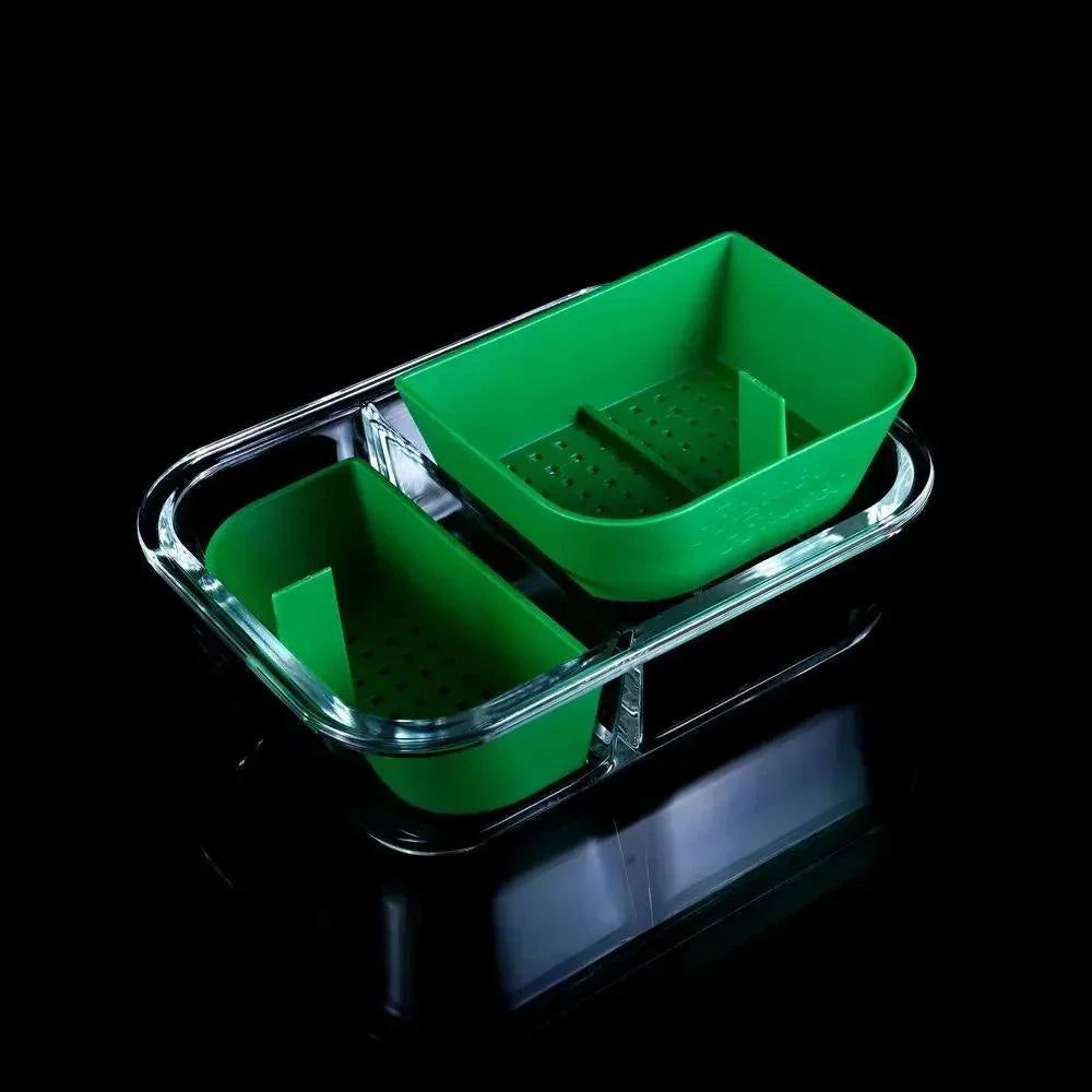 Green silicone basket with perforated base in a clear tray, smoking accessory organizer.