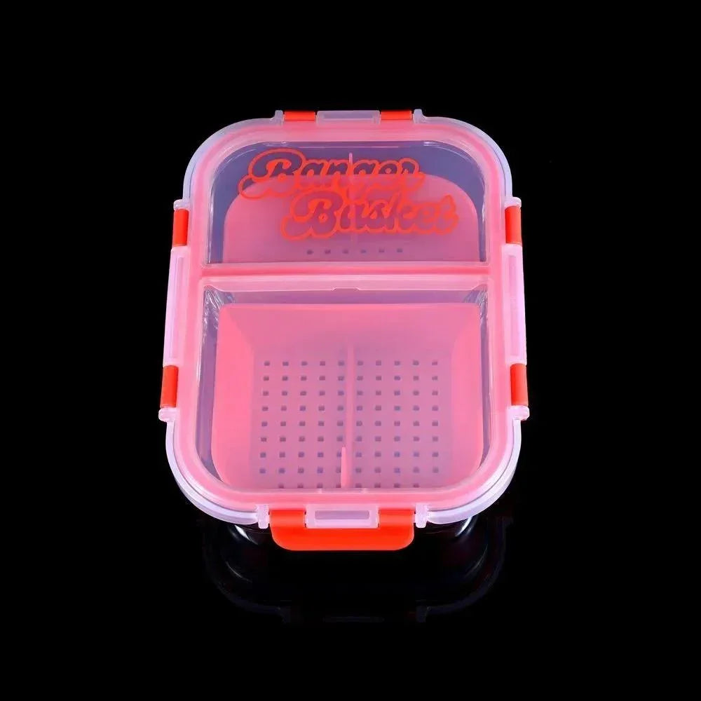 Red and clear plastic storage container with compartments and snap lid on black background