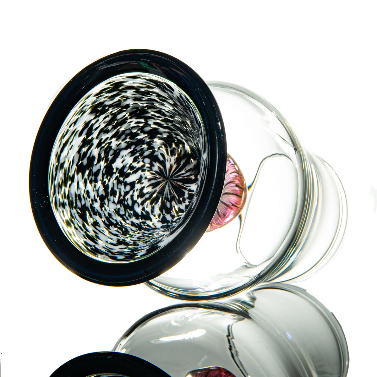 Artistic glass pipe with black and white swirl design and clear body on white background