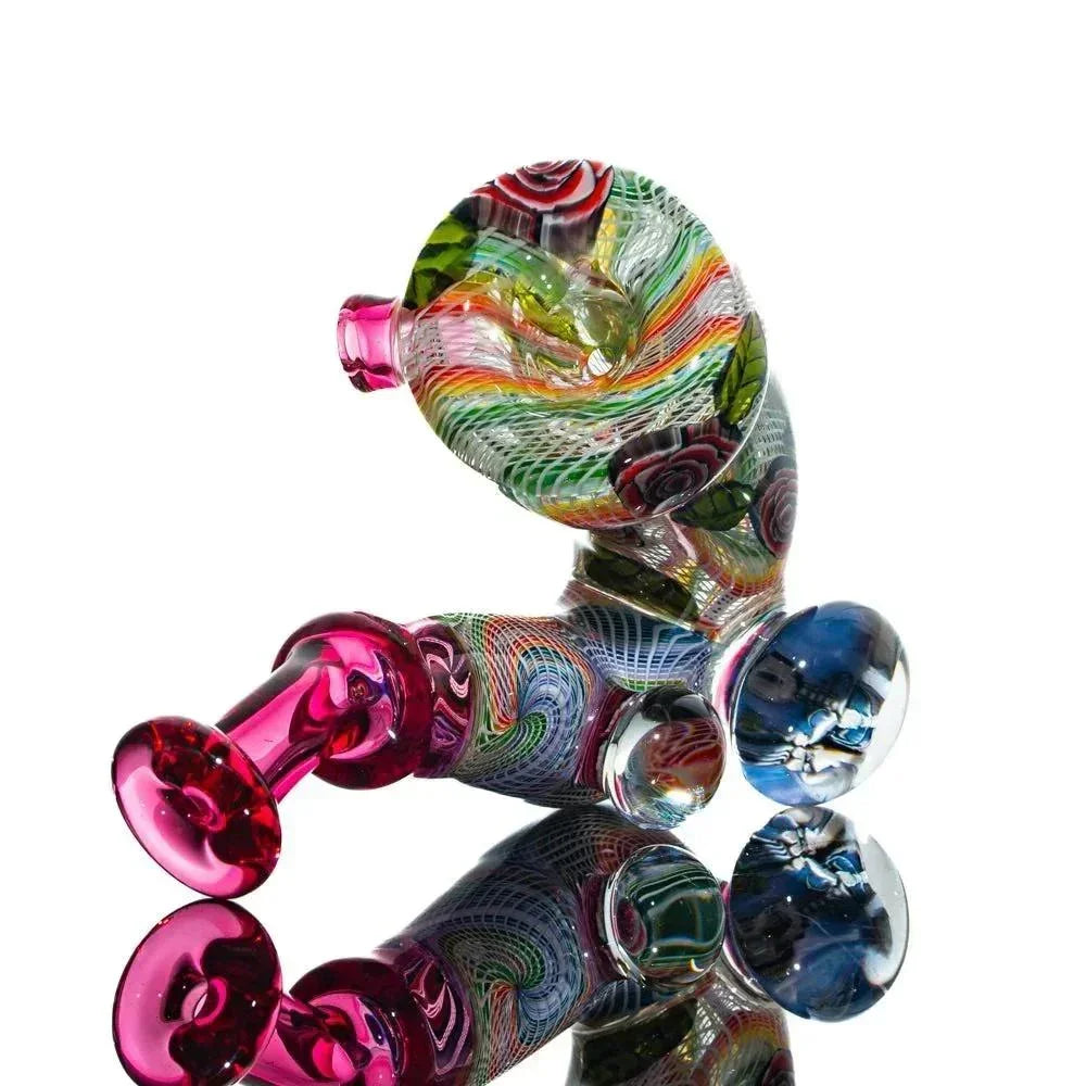 Colorful hand-blown glass pipe with swirled abstract patterns and reflective accents