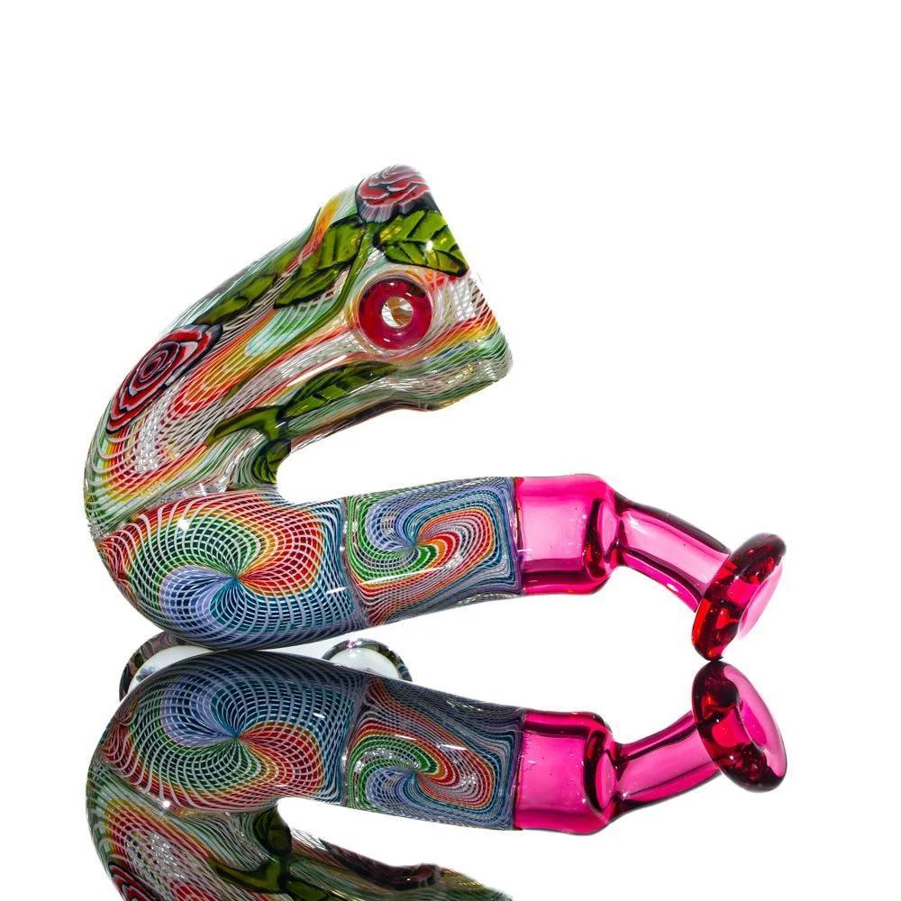 Colorful hand-blown glass pipe with intricate swirls and leaf designs on white background